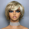 Mannequin head with blonde wig and floral off-shoulder top against a gray background