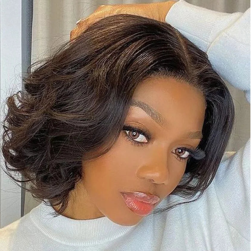 Woman with styled hair wearing a light gray sweater indoors.
