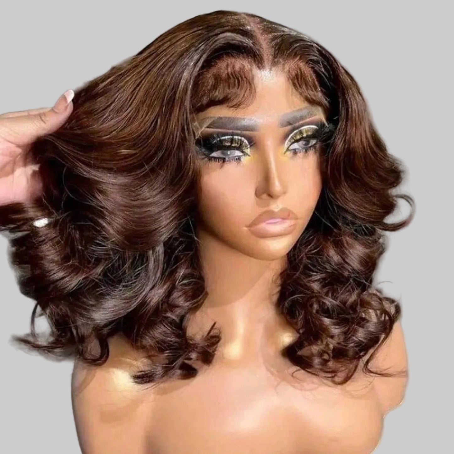 Brown wig on a mannequin head with a blurred background